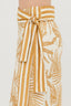 Yellow and white patterned skirt with a tie waist on a light gray background