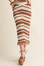 Brown and white striped crochet skirt worn by a person on a beige background