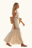 Woman in a coastal beige halter cut out maxi dress