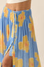 Blue skirt with yellow floral patterns on a beige background