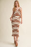Woman wearing a brown and white striped dress on a plain background