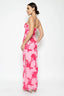 Woman wearing a pink floral dress on a white background