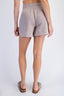 Person wearing gray shorts on a white background