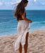 Woman on a beach with ocean view wearing a patterned sarong.
