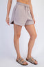 Person wearing gray shorts on a white background
