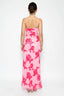 Woman wearing a pink floral dress on a white background
