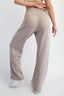 Beige sweatpants worn by a person on a white background