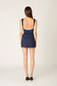 Woman wearing a navy blue dress on a white background