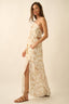 Woman wearing a floral dress with a slit on a beige background