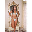 Woman in a light blue bikini standing in an ornate room.