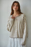 Woman wearing a striped cardigan against a plain background