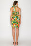 Woman wearing a colorful floral dress with a white background