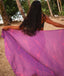 Woman holding a purple fabric with pink leaf pattern in a tropical setting