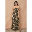 Woman wearing a strapless floral dress against a beige background
