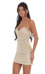 Woman wearing a beige strapless dress on a white background