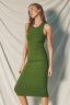 Woman wearing a green dress against a plain background