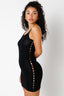 Woman wearing a black dress with cut-out design on a white background