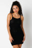 Woman wearing a black crochet cover up dress with a textured pattern on a white background