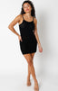Woman wearing a black dress with a textured pattern on a white background