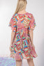Woman wearing a colorful patterned dress on a white background
