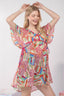 Woman wearing a colorful patterned dress on a white background