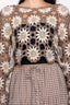 Close-up of a person wearing a crochet top with a checkered skirt.