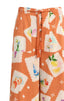 Pajama pants with a colorful pattern on an orange background