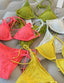 Colorful bikini sets displayed on a gray surface