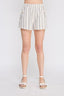 Person wearing white striped shorts on a plain background