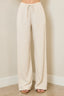 Beige wide-leg pants worn by a person on a plain background