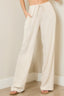 Beige wide-leg pants worn by a person against a plain background