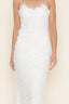 White lace top and maxi skirt set on a plain background