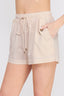 Beige shorts with a drawstring and pocket on a white background