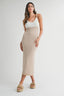 Woman wearing a taupe beachy midi dress on a white background