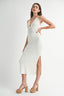 Woman wearing a white dress with a V-neck and slit on a white background