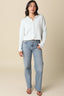 Woman wearing a striped shirt and jeans against a beige background