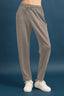 Gray sweatpants worn by a person on a blue background