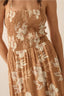 Brown floral dress with smocked waist on a beige background