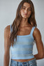 Woman wearing a light blue striped tank top 