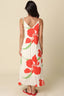 Woman wearing a floral dress with red flowers on a beige background
