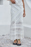 Person wearing a white lace asymmetrical designed skirt