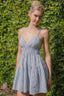 Striped V-Neckline Mini Dress with adjustable straps, smocked waist, and a chic cut-out back.