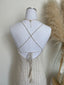 White decorative vase with string design on a light background