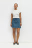 Person wearing a white t-shirt and blue denim skirt on a white background