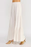 White wide-leg pants worn by a person on a white background