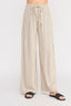 Beige striped pants worn by a person on a white background