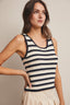Woman wearing a striped sleeveless top against a neutral background