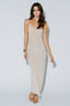 Woman wearing a beige slip dress on a white background