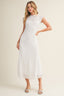Woman wearing a white lace dress on a plain background