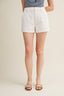 Person wearing white shorts on a plain background